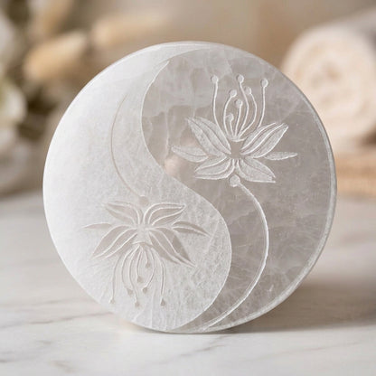 Plaque ronde en sélénite vue de dessus, gravée d’un motif yin-yang composé de deux fleurs de lotus
